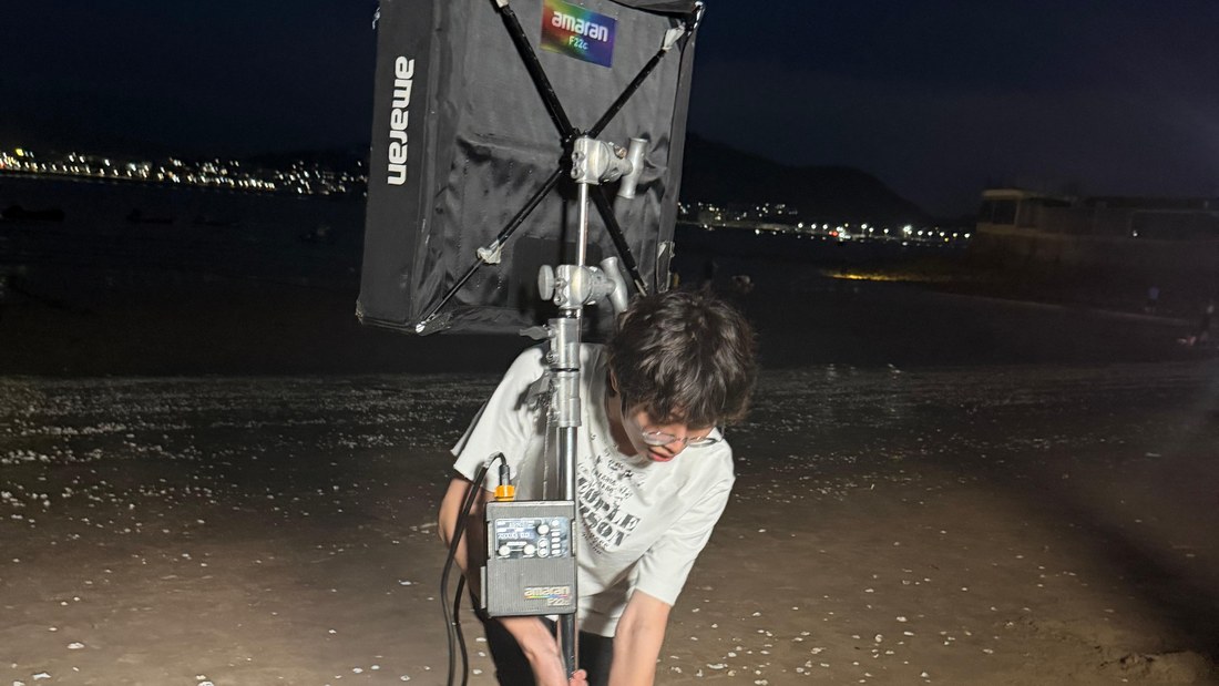 On set — lighting stand and kit cases during a shoot day